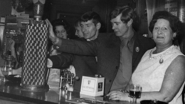 A British pub scene from the 1950s with family members being the bar